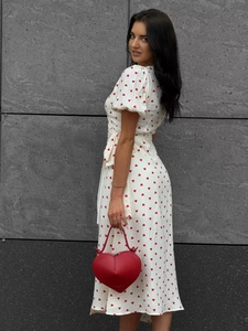 Detail view of the red heart print cotton dress with puff sleeves and waist tie