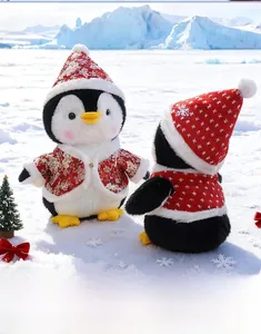 Close-up of plush Christmas penguin toys in red festive scarves on a polar ice background