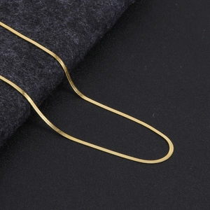 Detailed view of the sleek gold snake chain necklace with a refined metallic texture