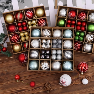 Detail view of assorted painted Christmas ornaments in various colors with a gift box