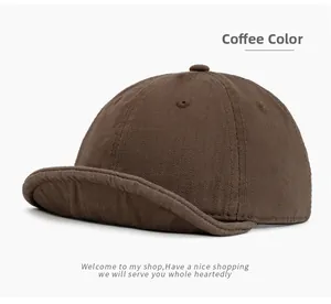 Close-up of the coffee brown cotton twill fabric and stitching on the short brim cap
