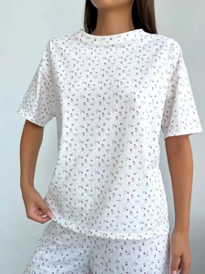 Detailed texture of cotton pajama set with red floral print and drop shoulder sleeves