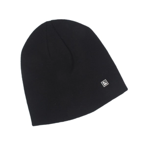 Close-up of black knitted beanie texture with a minimalist square logo patch detail