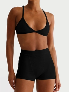 Women's black ribbed camisole bra and yoga shorts set with a minimalist Y2K style