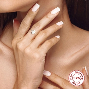 Close-up of a 925 sterling silver marquise cut diamond ring on a model's finger