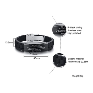 Detail view of engraved stainless steel plate on black silicone bracelet with size specs