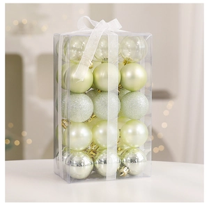 Detail of Christmas tree balls in lime green with matte and glitter finishes in a gift box