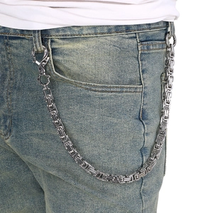 Punk style silver Byzantine chain pant link accessory worn on blue denim jeans
