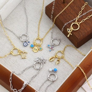 Close-up of vintage S925 silver necklaces with star, moon, and blue opal eye pendants