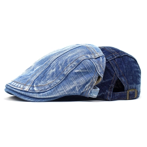 Detail of blue denim beret hats showing premium stitching and metal adjustable buckle