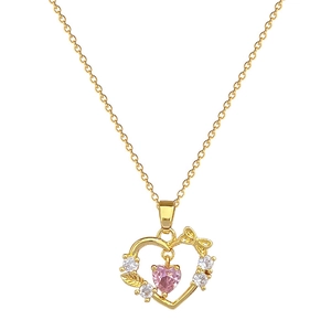 Luxurious gold titanium necklace with sparkling pink heart stone and bow detail