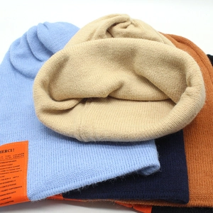 Thick knitted beanie with wool texture and colorful MERCI patches for winter warmth