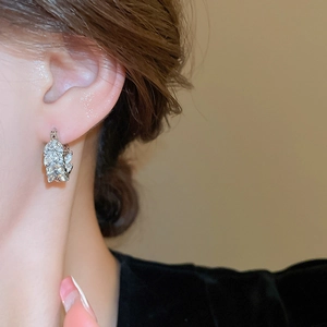 Close-up of model wearing silver wheat ear hoop earrings with marquise-cut cubic zirconia