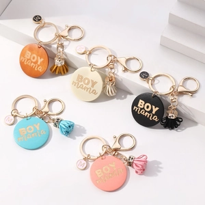 BOY MAMA keychain set with colorful tassels, engraved wooden charms, and M pendants