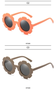 Close-up of flower shaped kids sunglasses in orange and brown with matte finish