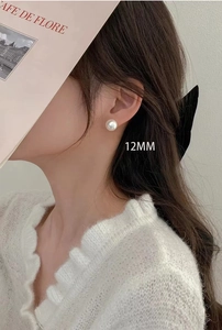 Detailed view of 12mm white pearl stud earring worn elegantly on a model's ear
