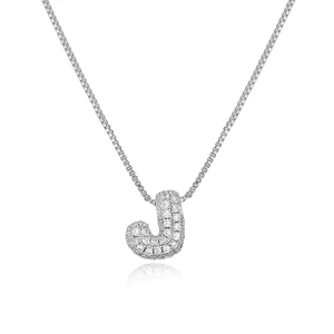 Macro view of silver copper pendant necklace featuring micro-paved zircon letter J