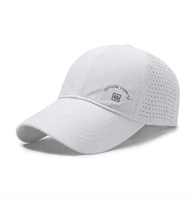 Detail of white breathable baseball cap showing laser-cut ventilation holes and side embroidery
