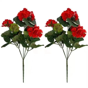 Detailed close-up of two artificial red geranium silk flower bouquets with green leaves