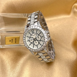 Close-up of a silver luxury ladies watch with full pavé crystals and three sub-dials