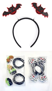 Close-up of Halloween headbands featuring bat wings, pumpkins, and skull motifs in packaging