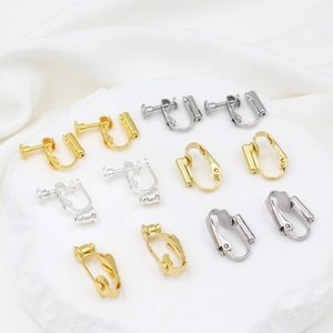 Macro shot of gold and silver screw adjustable U-shaped ear clip converters for DIY jewelry