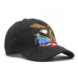 Close-up of eagle embroidery and American flag stripes on black cotton baseball cap