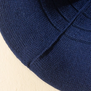 Macro detail of the dark blue knitted fabric and fine stitching on the witch hat brim