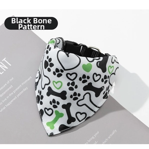 Detail of dog bandana collar with black and green bone patterns and metal D-ring buckle