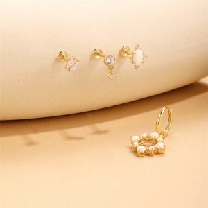 Detailed shot of S925 sterling silver gold earrings with opal and zircon flower charms