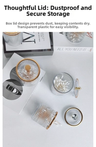 Detail of transparent fluted storage jar with a gold handle for cotton swabs