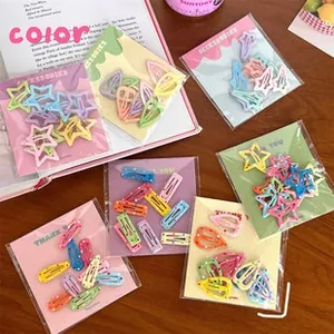 Macro detail of colorful macaron hair clips in star and teardrop shapes for girls