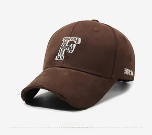 Detail view of the vintage brown baseball cap with white F letter embroidery and distressed brim