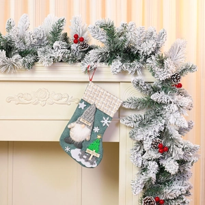 Close-up of burlap Christmas stocking featuring 3D gnome doll and festive snowflake appliques