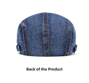 Back view of dark blue denim ivy cap with orange stitching and metal buckle