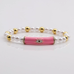 Evil eye bracelet with white imitation pearls, gold beads and pink enamel tube detail