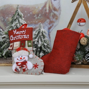 Festive Christmas stockings with snowman design and Merry Christmas embroidery on a mantel