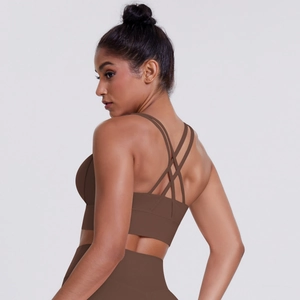 Detail of dark brown sports bra featuring multiple criss-cross back straps and sleek texture