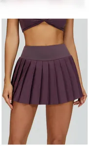 Detailed view of grape purple pleated tennis skirt and matching halter sports bra set