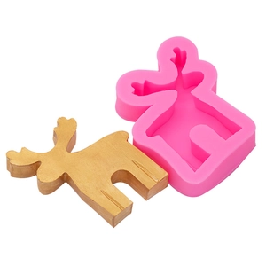 Close-up of pink silicone reindeer mold and a finished golden DIY Christmas decoration