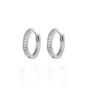 Detail of silver huggie earrings with sparkling clear cubic zirconia stones and mirror reflection