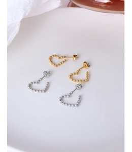 Macro shot of irregular beaded heart earrings in 18k gold and silver plated finish