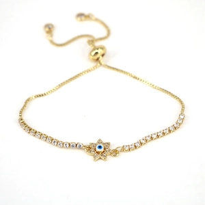 Detail of adjustable gold evil eye star bracelet with inlaid white zircons