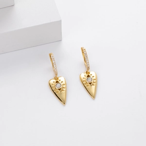 Detail of gold heart earrings featuring white opal center and sparkling zircon stones