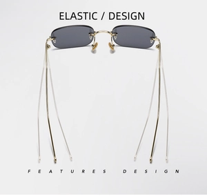 Close-up of flexible golden metal temples and rimless grey square lenses on sunglasses