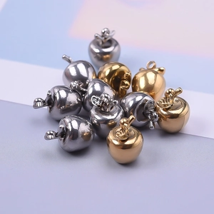 Close-up of apple-shaped 304 stainless steel pendants in gold and silver for DIY jewelry