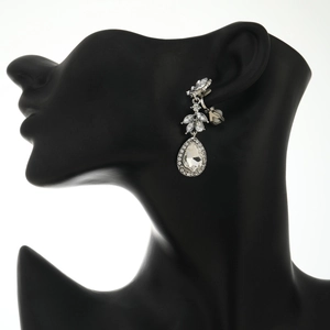 Elegant silver clip-on drop earrings with teardrop crystals on a black jewelry bust