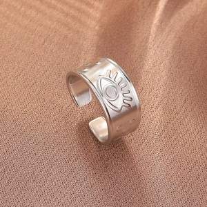 Detailed close-up of a silver stainless steel adjustable ring featuring an evil eye engraving