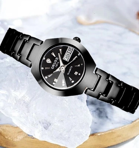 Détail d'une montre à quartz en acier noir sur glace avec date et index argentés
