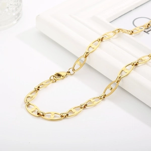 Detail of golden pig nose chain necklace with lobster clasp and anchor link design